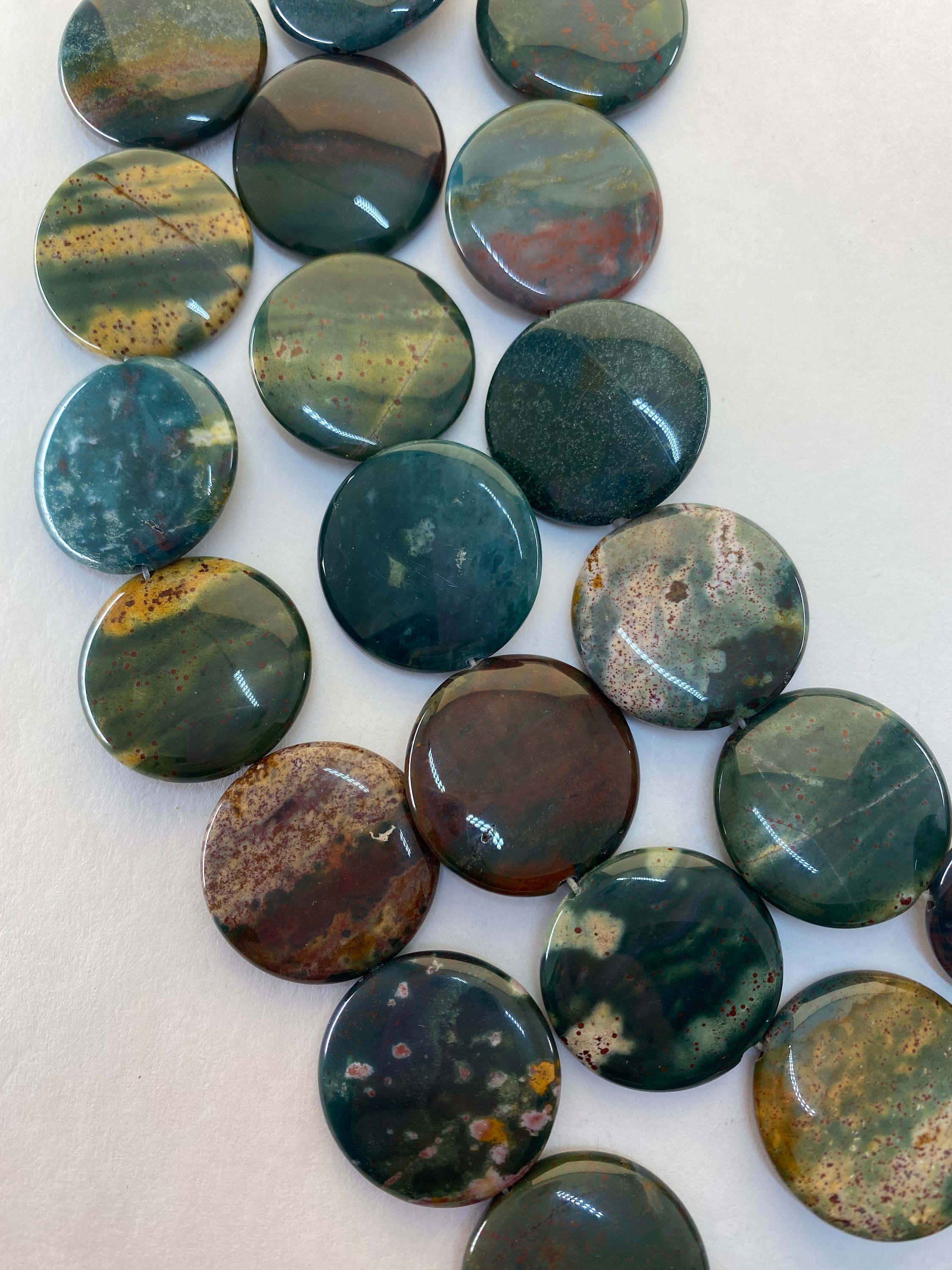 25mm Puff Coin Shaped Dark Green Blood Stone Jasper. Full 15" Strand High Quality Beads In Rich Green With Dabs Of Red, Yellow And Blue.