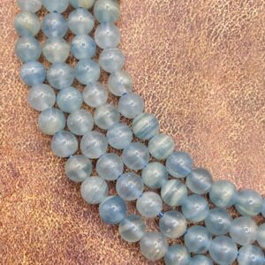 6mm Argentina blue Calcite grade A gemstone beads. 15” strand of clear blue round beads, 62 per strand.