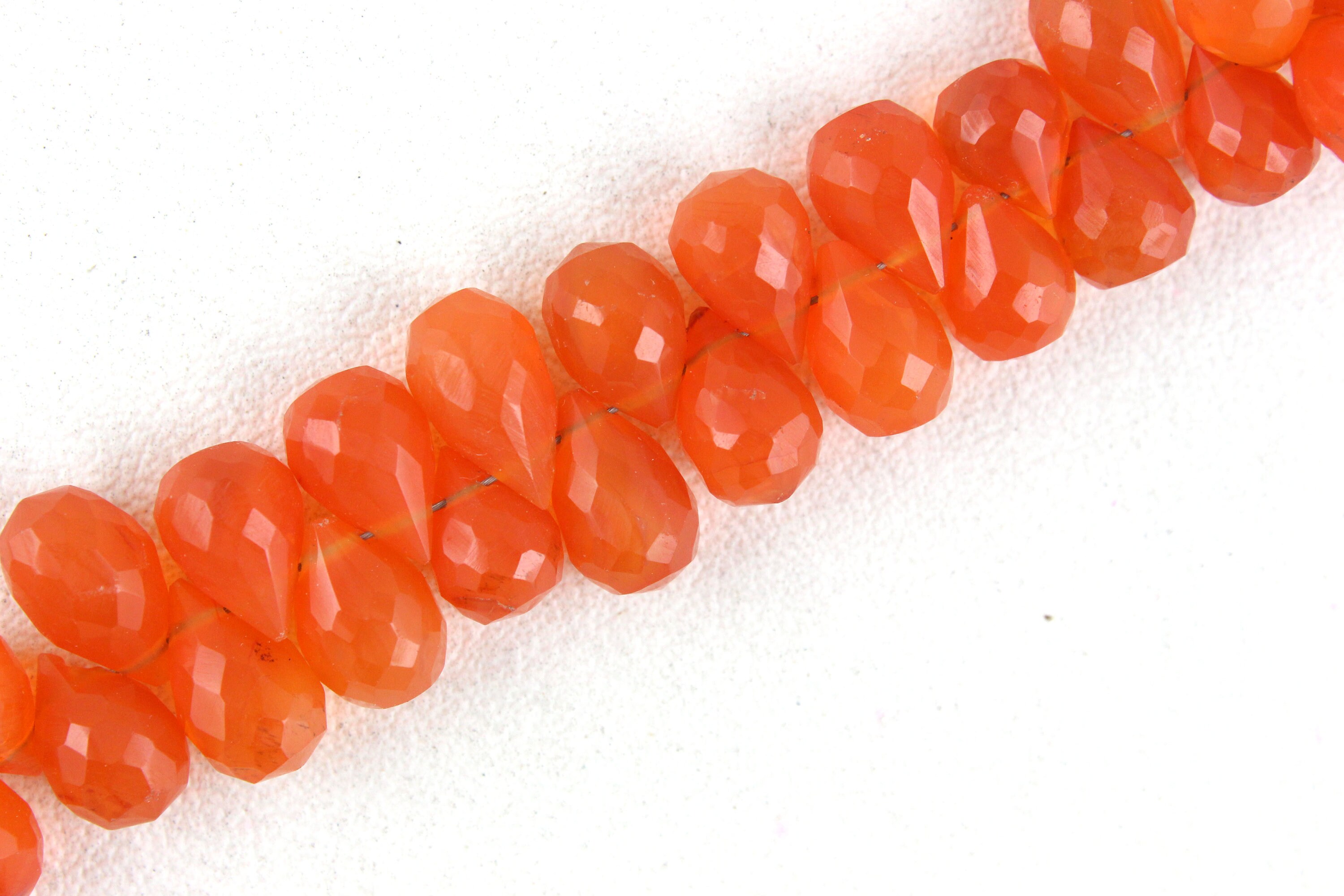 Faceted Carnelian Tear Drop Beads: 10" Strand, 6x8-7x11 Mm Faceted Carnelian Tear Drop Beads: 10" Strand, 6x8-7x11 Mm