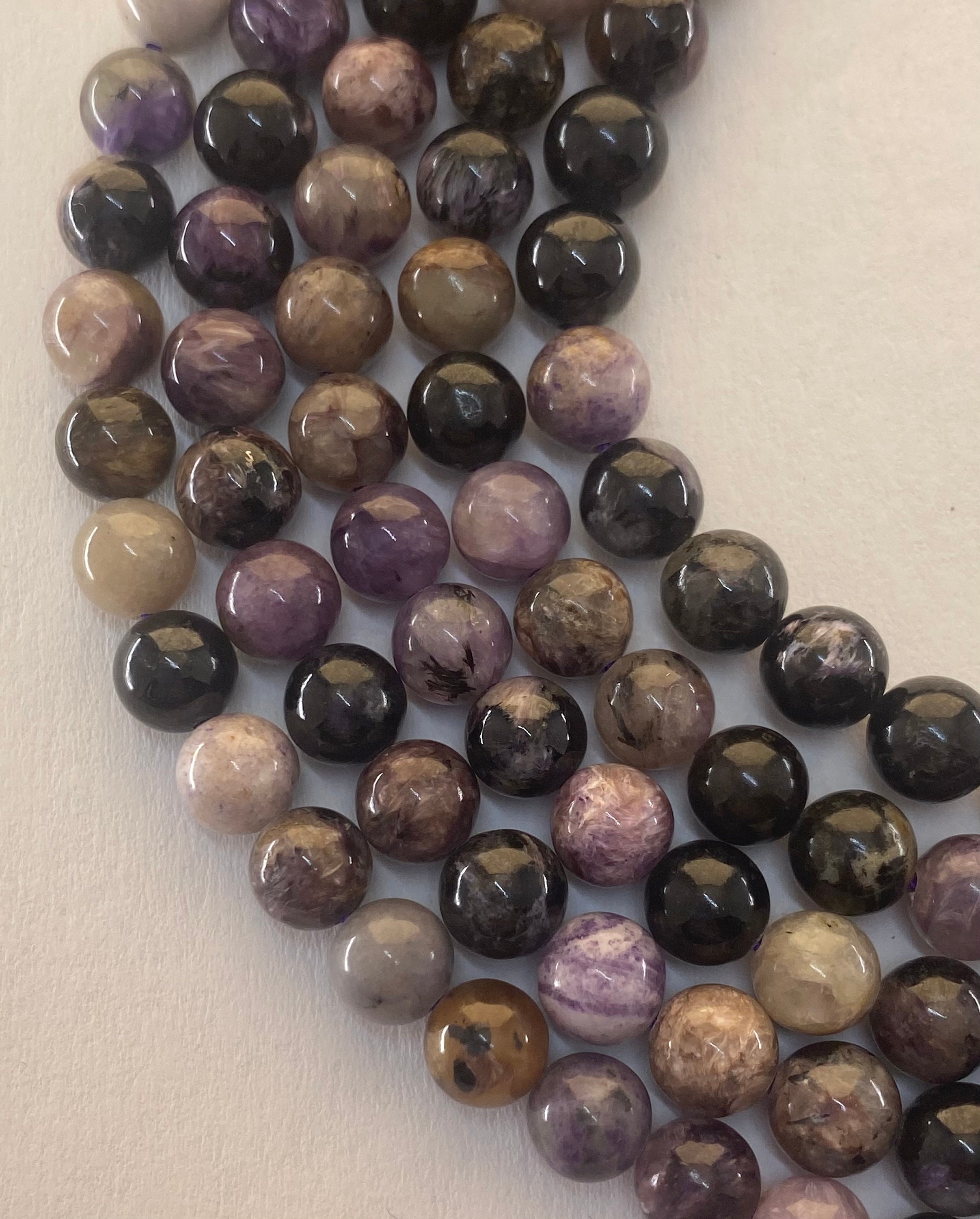 6mm Russian Charoite Gemstone Beads. 15" Strand Of High Quality Beads, About 62 Beads Per Strand. Mixed Purples With Black And White. 6mm Russian Charoite Gemstone Beads. 15" Strand Of High Quality Beads, About 62 Beads Per Strand. Mixed Purples With Black And White.