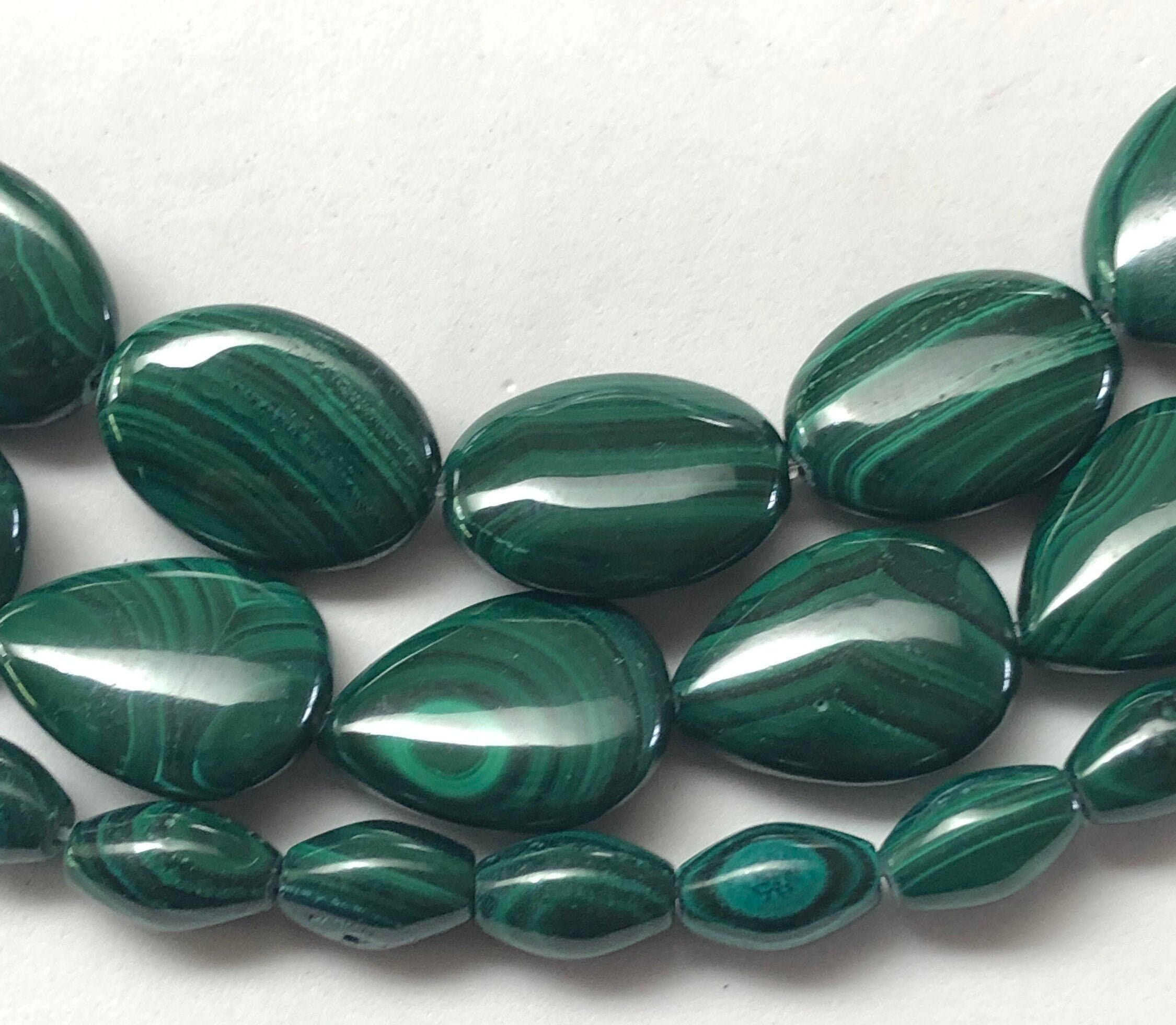 Genuine Malachite Beads On 15 Inch Strand. Rice, Oval And Teardrop Shapes Available. Full Strand Of Beautiful Dark Green Aa/aaa Grade Beads.