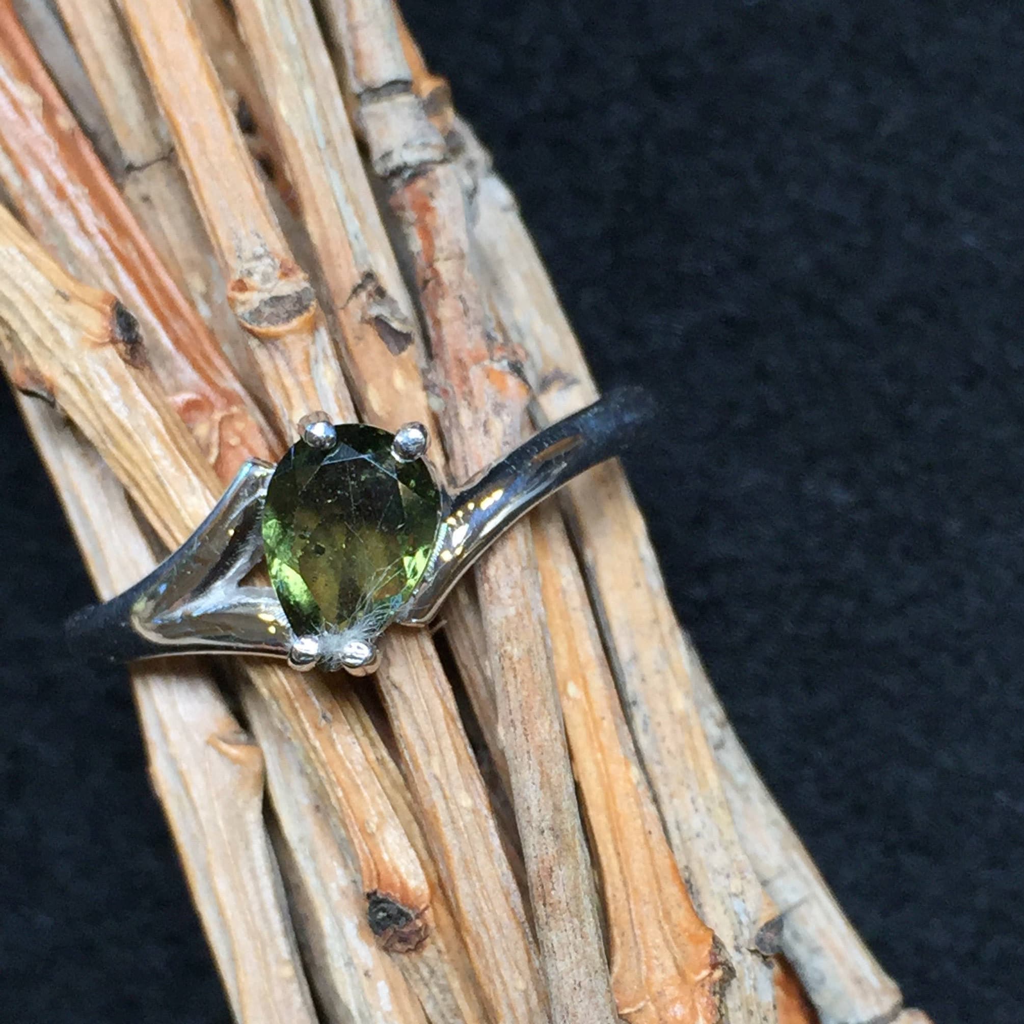 Little Dancer: A 5x7mm Faceted Moldavite And Sterling Silver Rhodium Plated Ring (5a) Little Dancer: A 5x7mm Faceted Moldavite And Sterling Silver Rhodium Plated Ring (5a)