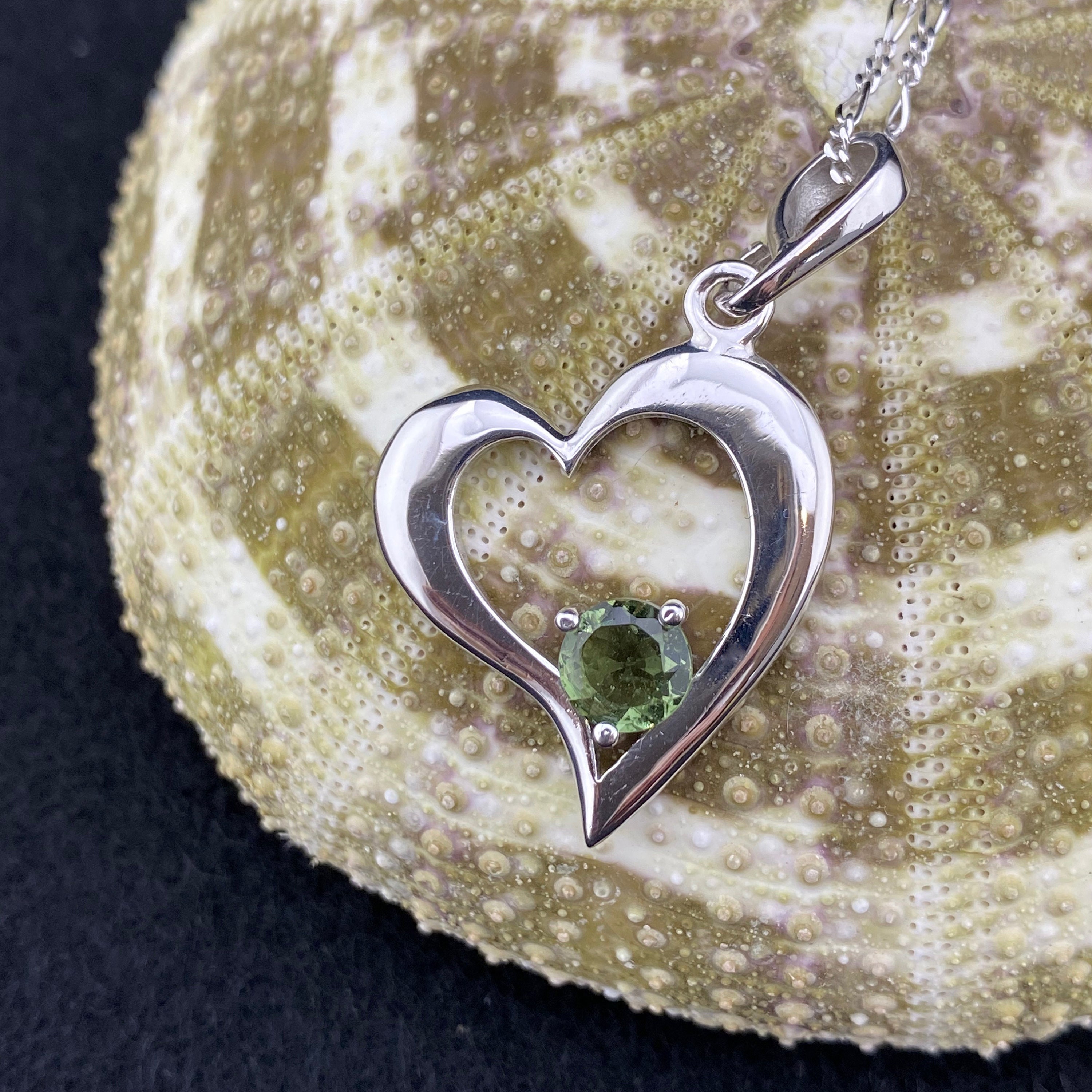 Heart Signature! A 6mm Round Genuine Faceted Moldavite Cradled In A Sterling Silver Rhodium Plated Heart Heart Signature! A 6mm Round Genuine Faceted Moldavite Cradled In A Sterling Silver Rhodium Plated Heart