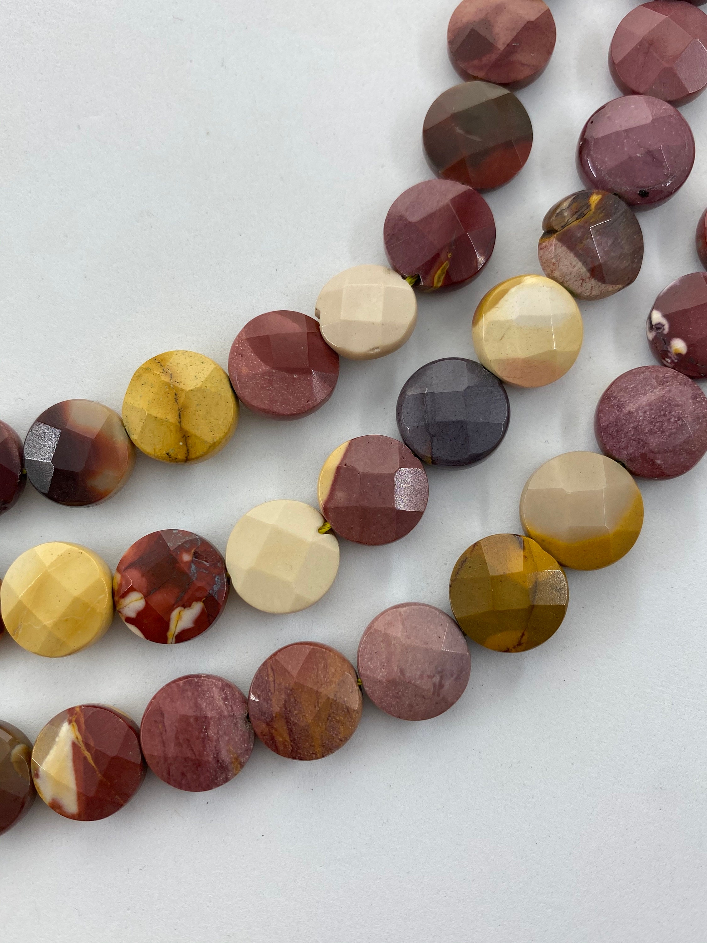 12mm Faceted Puff Coin Mookaite Gemstone Beads. 15” Strand Of High Quality Coin Beads, Roughly 32 Beads Per Strand. Mooka Jasper 12mm Faceted Puff Coin Mookaite Gemstone Beads. 15” Strand Of High Quality Coin Beads, Roughly 32 Beads Per Strand. Mooka Jasper
