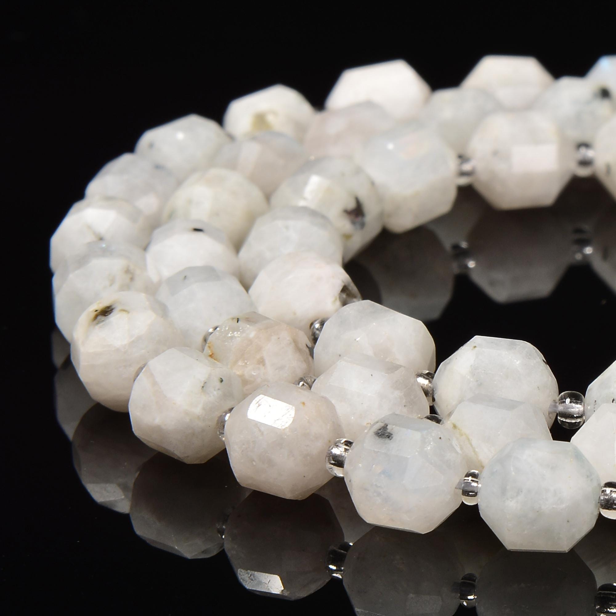 White Moonstone With Black Specks Prism Cut Double Point 9x10mm 15.5'' Strand White Moonstone With Black Specks Prism Cut Double Point 9x10mm 15.5'' Strand