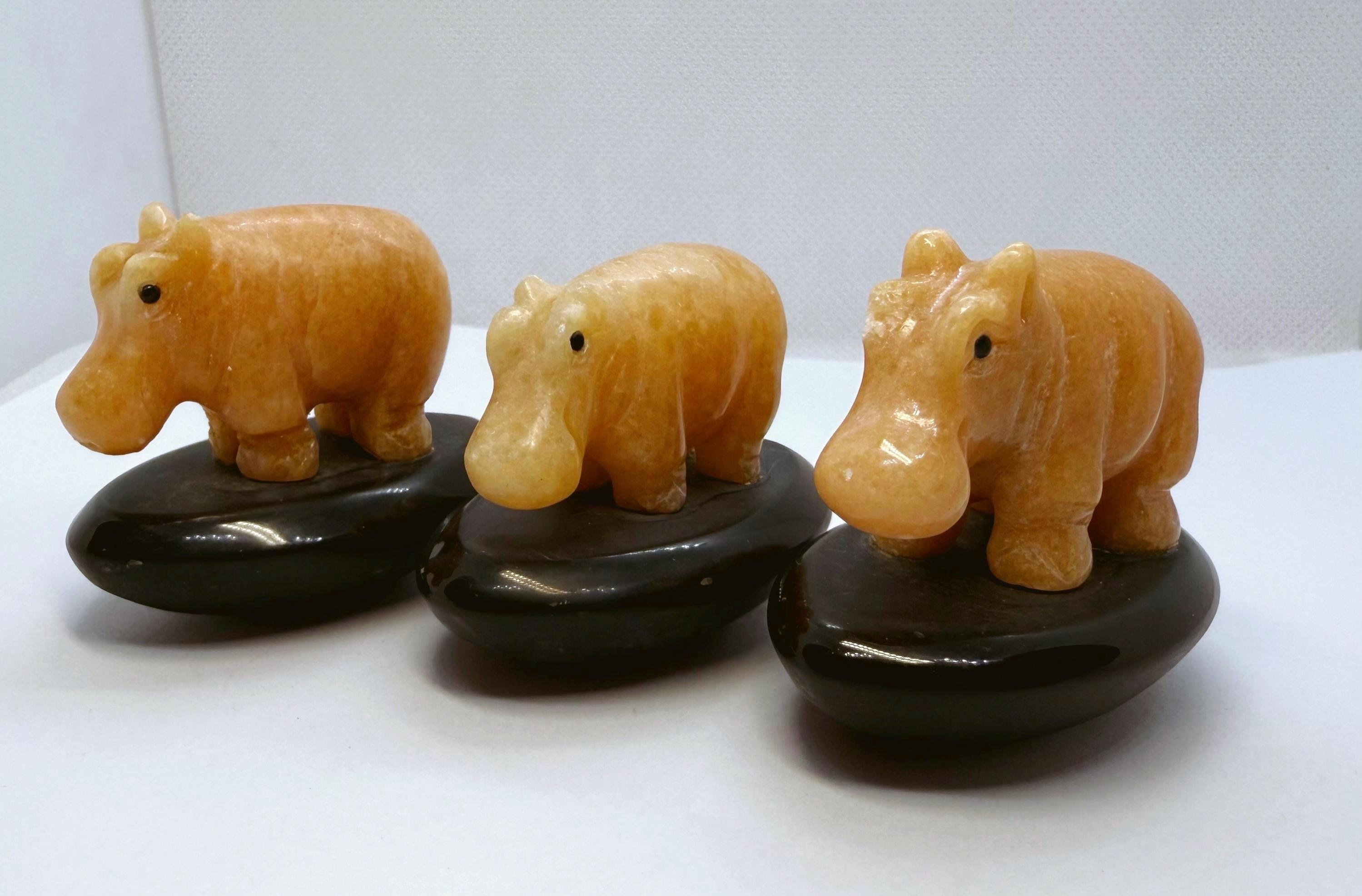 Hand-carved Orange Calcite Hippo Figurines On Agate Bases.