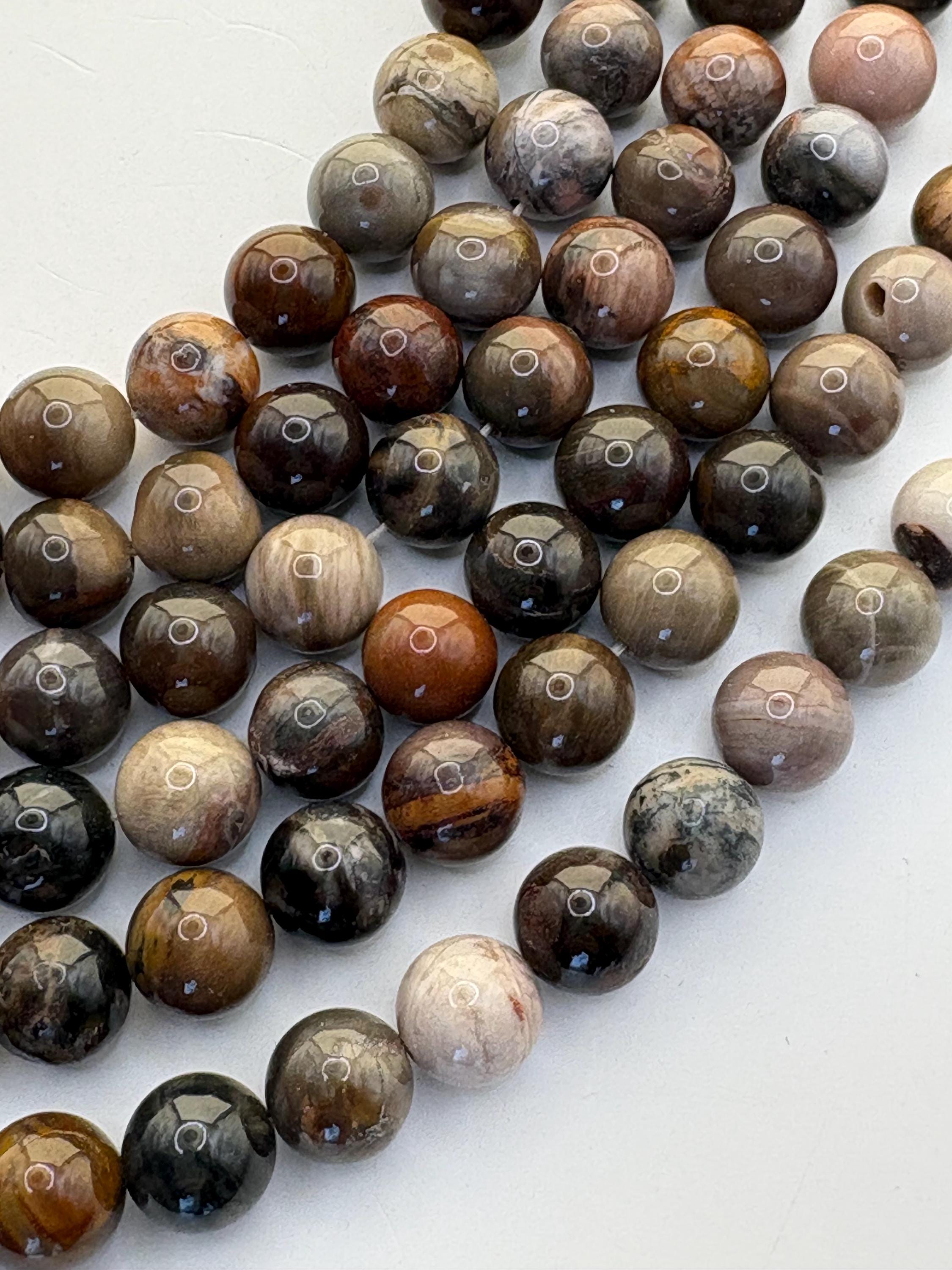10mm Round Petrified Wood Beads. 15” Strand Of Earth Tone Beads, 38 Per Strand. Wooden Agate Beads. 10mm Round Petrified Wood Beads. 15” Strand Of Earth Tone Beads, 38 Per Strand. Wooden Agate Beads.