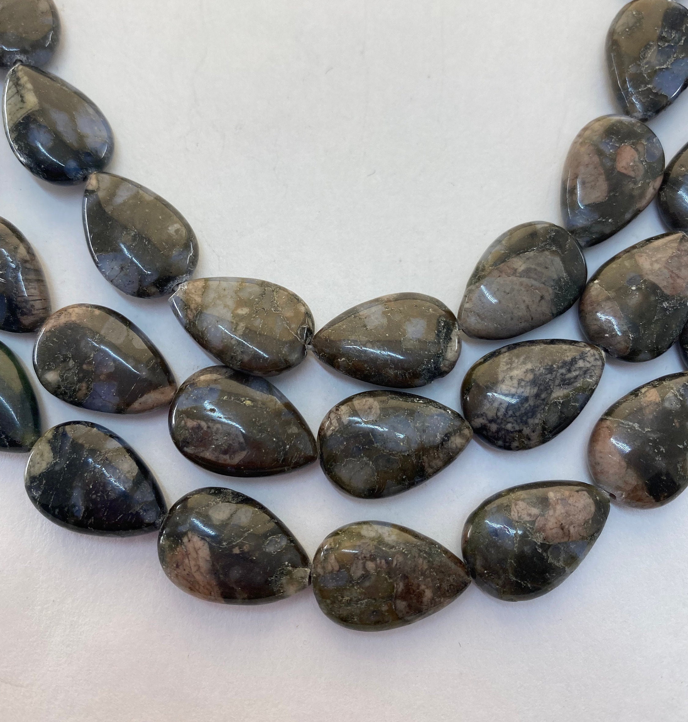 13x18mm Teardrop Shaped Blue Riolita Gemstone Beads. 15” Strand Of Black, Brown And Blue Teardrops, 22 Per Strand. A Form Of Rhyolite.