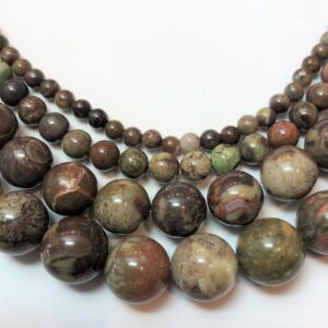 Dark Green Rain Forest Jasper Gemstone Beads. Full 15" strand of round AA/AAA grade beads. Dark green Rhyolite with orange. Dark Green Rain Forest Jasper Gemstone Beads. Full 15" strand of round AA/AAA grade beads. Dark green Rhyolite with orange.