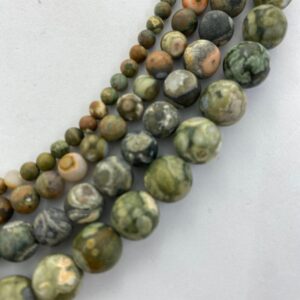Matte Green Rhyolite Gemstone Beads, available in 4-10mm. 15” strands of round beads. Sometimes called Rain Forest Stone. Matte Green Rhyolite Gemstone Beads, available in 4-10mm. 15” strands of round beads. Sometimes called Rain Forest Stone.