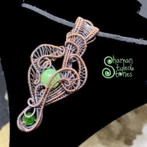 Reversable Green calcite bead with diopside, shaman styled in oxidized copper Reversable Green calcite bead with diopside, shaman styled in oxidized copper