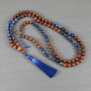 Faceted sodalite and sandalwood hand-knotted mala with a silky blue tassel Faceted sodalite and sandalwood hand-knotted mala with a silky blue tassel