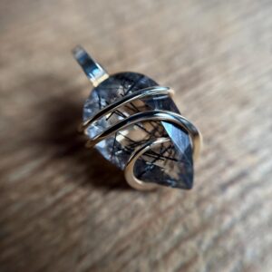 Faceted tourmalinated quartz in 14k gold pendant