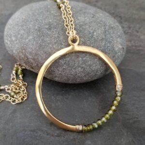 Olive green vesuvianite circle necklace, gold crescent pendant with idocrase beads and beaded gold filled chain. Olive green vesuvianite circle necklace, gold crescent pendant with idocrase beads and beaded gold filled chain.