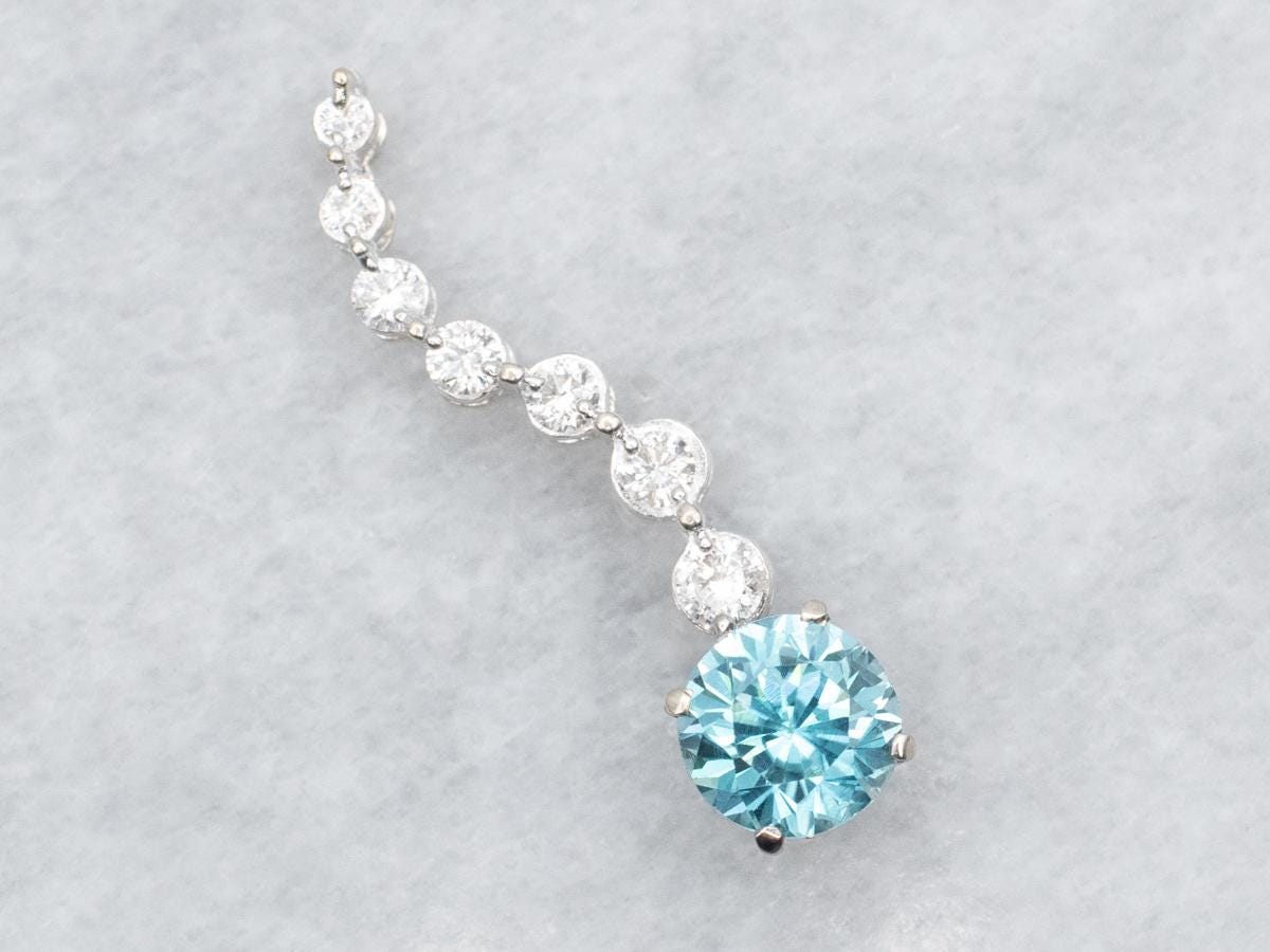 14k White Gold Blue Zircon And Diamond Swirl Pendant
