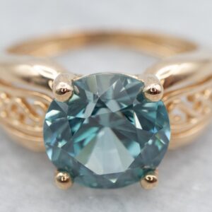 Yellow Gold Blue Zircon Solitaire Ring With Filigree Shoulders Yellow Gold Blue Zircon Solitaire Ring With Filigree Shoulders