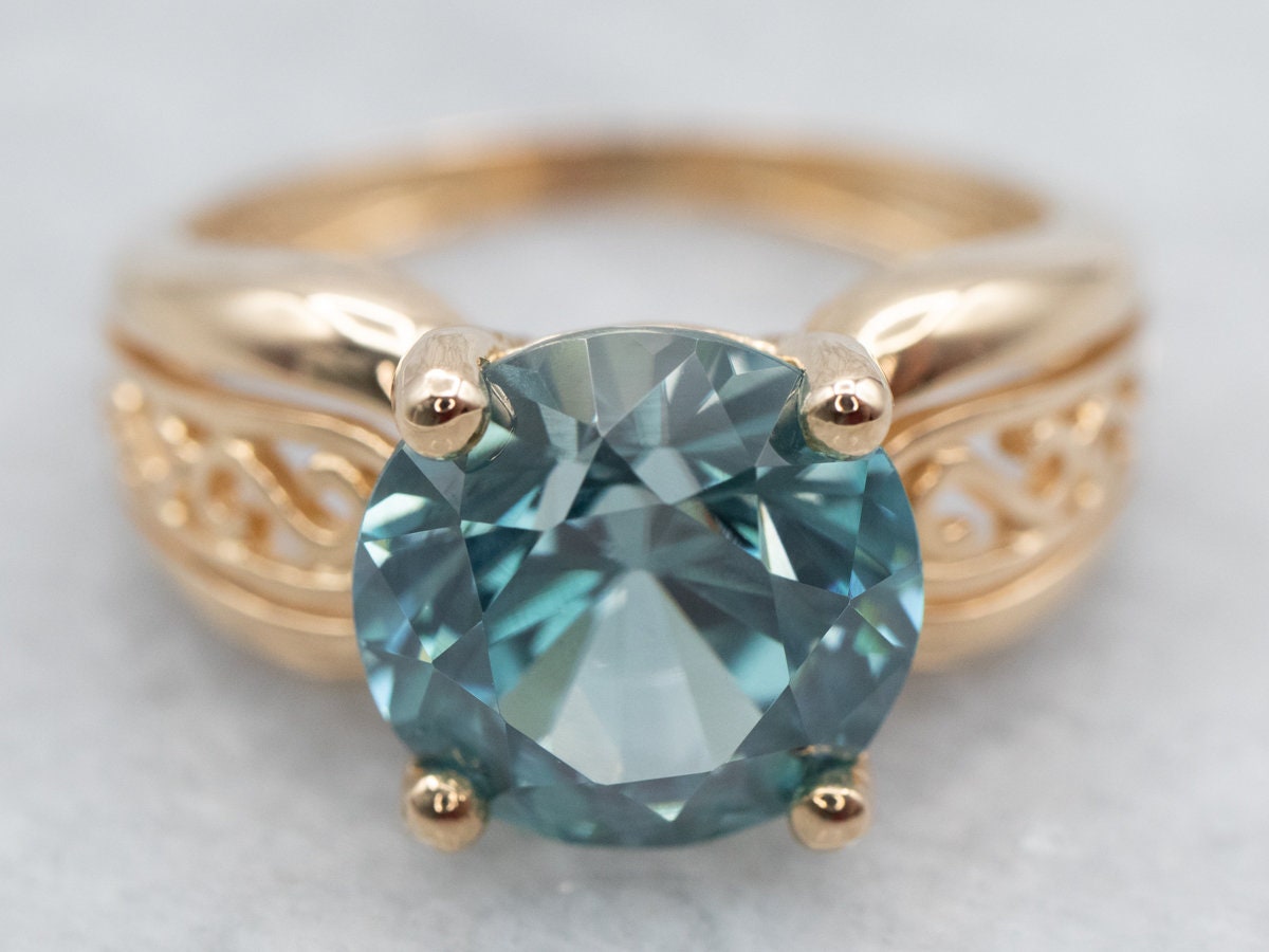 Yellow Gold Blue Zircon Solitaire Ring With Filigree Shoulders
